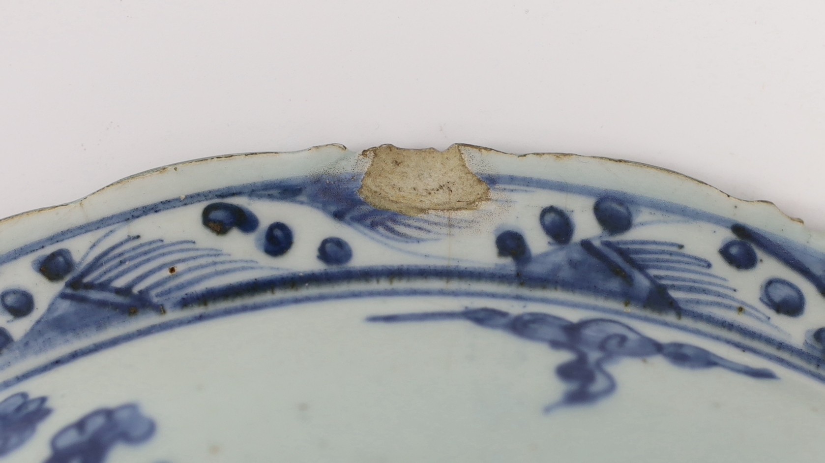A Chinese Ming blue and white ‘lion’ dish, four character Ming mark, 31cm diameter, chip and cracks